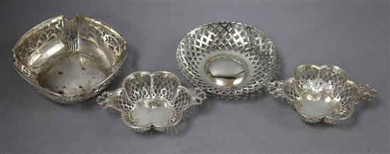 A pair of Edwardian pierced silver two handled bonbon dishes, Birmingham, 1909 and two other bonbon dishes, 10 oz.